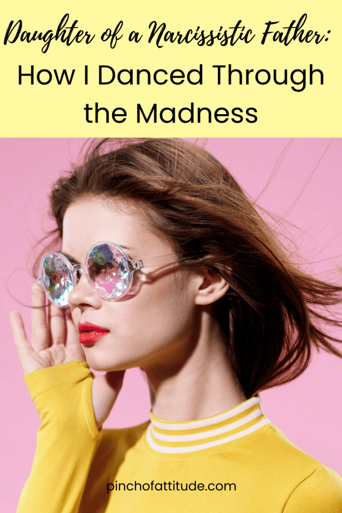 Pinterest - Pin with title "Daughter of a Narcissistic Father: How I Danced Through the Madness" showing a woman in colorful, reflective sunglasses and a yellow top against a pink background.