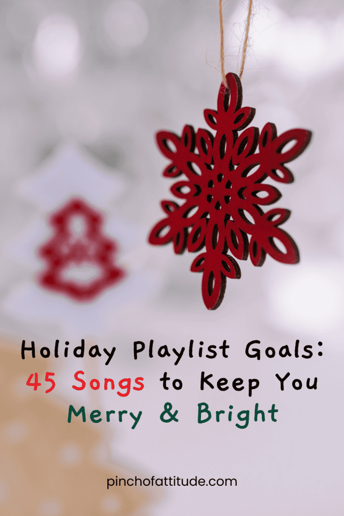 Pinterest - Pin with title "Holiday Playlist Goals: 45 Songs to Keep You Merry & Bright" featuring a close-up of a red snowflake ornament hanging on a blurred festive background.