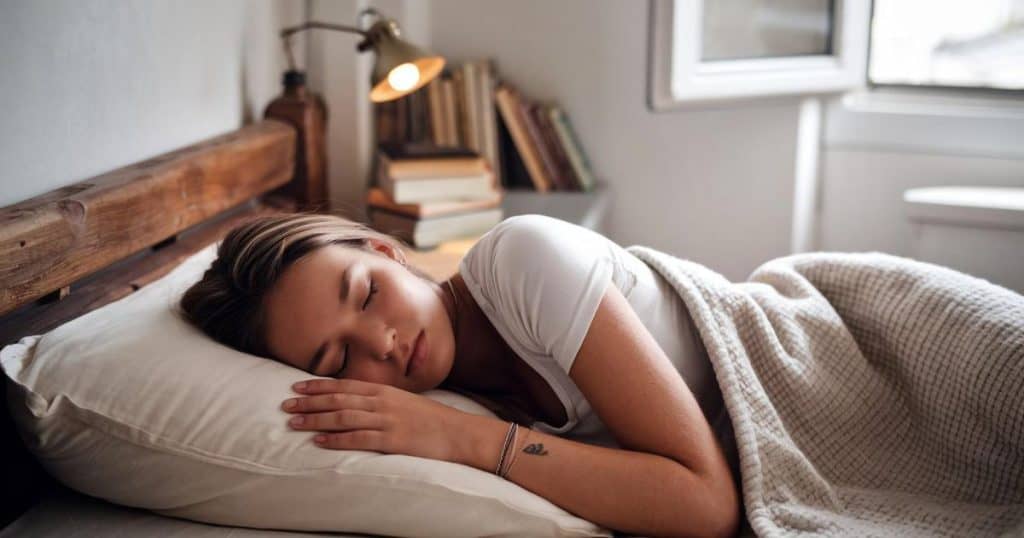 a woman sleeping comfortably in her bed.