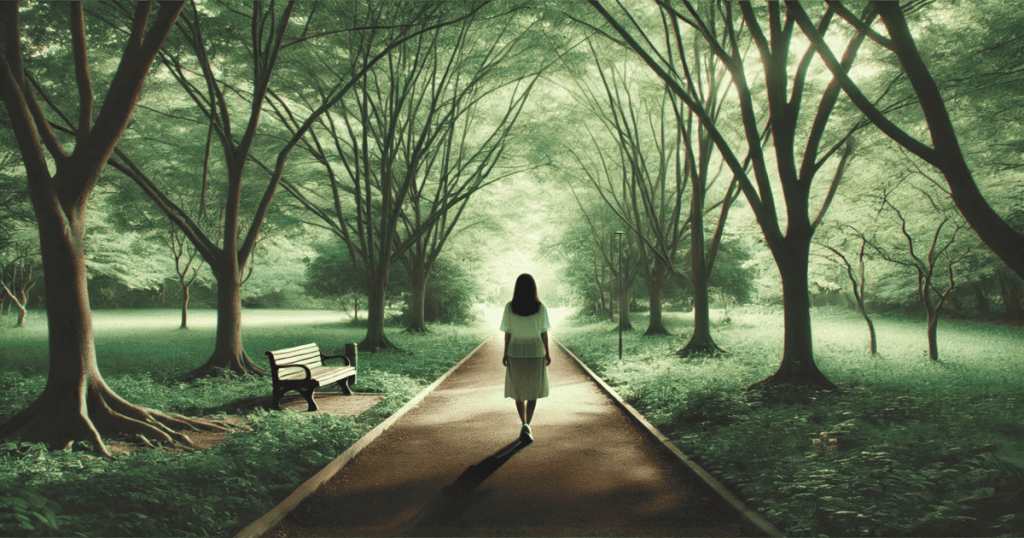 A woman walking along a tree-lined path in a quiet park, surrounded by nature with soft natural light.