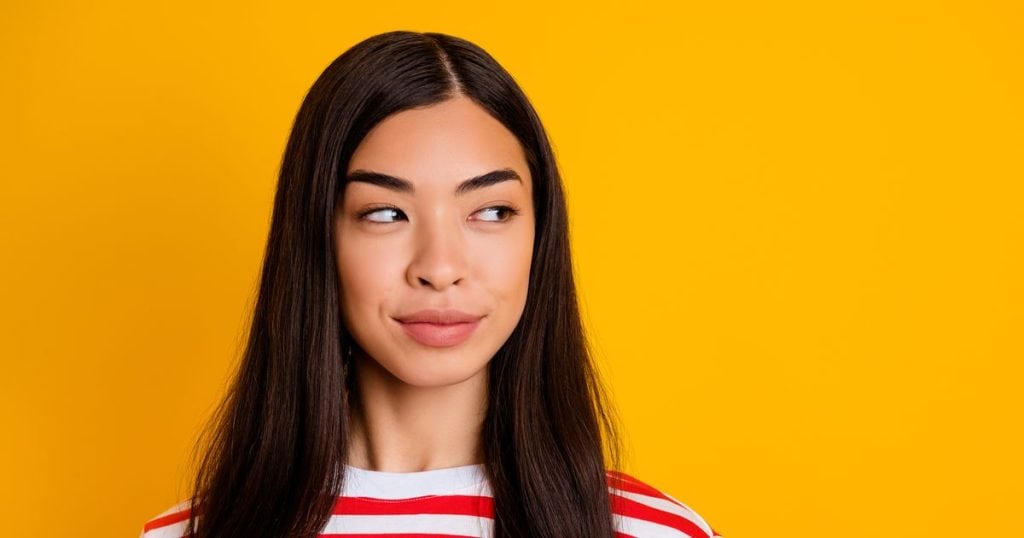 young woman with a secretive smile.