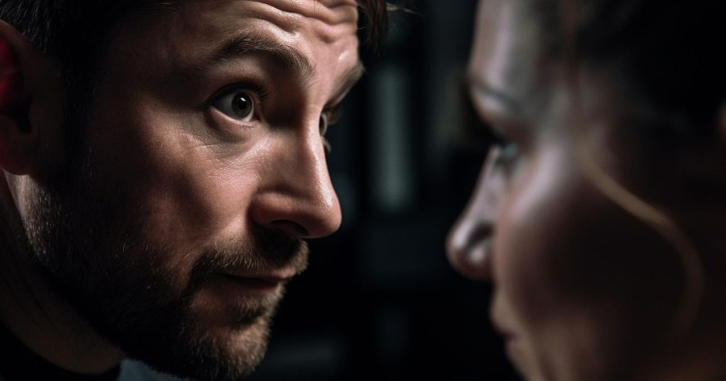 a closed up image of a man with wild eyes open looking scary is staring at his ex girlfriend who's feeling insecured with his presence.