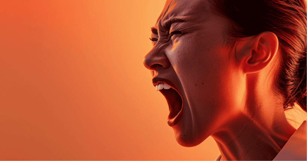 A close-up image of a woman screaming in anger, her face contorted with emotion and veins visible on her neck, set against a dramatic orange-red background. An intense visual representation of rage and emotional turmoil, echoing the personal impact of character assassination through smear campaigns.