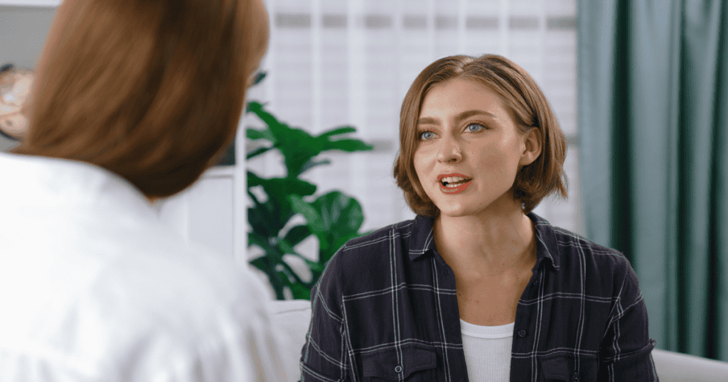 A woman speaks with visible frustration, trying to explain herself after her narcissistic mother twisted the truth to make her the villain again.
