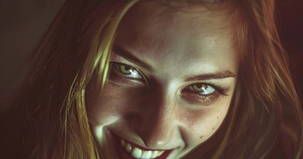 A close up picture of a young, sensual woman with a mysterious smile.