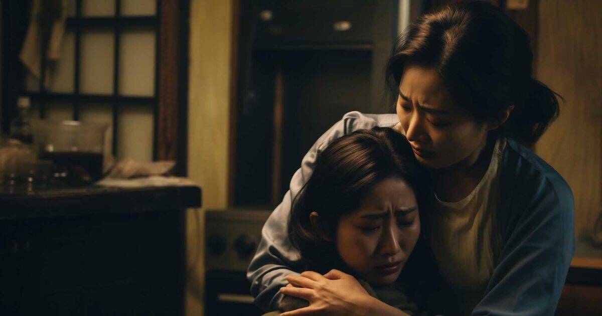 Two women in a dimly lit room; one appears emotionally distressed and vulnerable, while the other leans over her with a firm grip and a calculating expression.