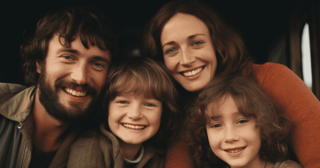 A joyful family of four smiles warmly at the camera, radiating love and togetherness.