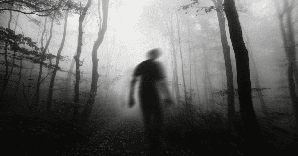 A blurred silhouette walks through a foggy forest, symbolizing the mysterious and transformative nature of life’s most defining moments and their lasting impact.