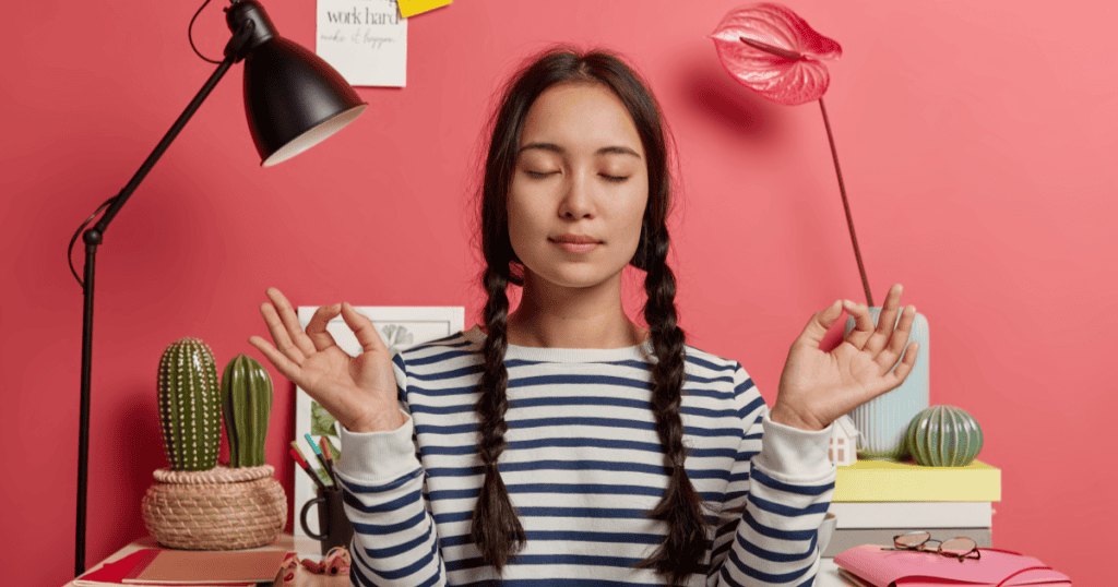 A calm woman sits with eyes closed and hands in a meditation pose, changing her mind without guilt after narcissistic pressure.