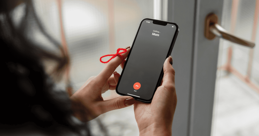 A phone lights up with an incoming call, but the red string tied to the finger says it all, this time, the reminder isn’t to answer. It’s to protect your peace, to remember that silence can be the strongest boundary of all.