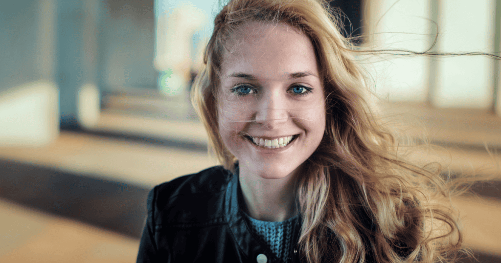 A narcissistic woman smiles while hiding emptiness behind her eyes.