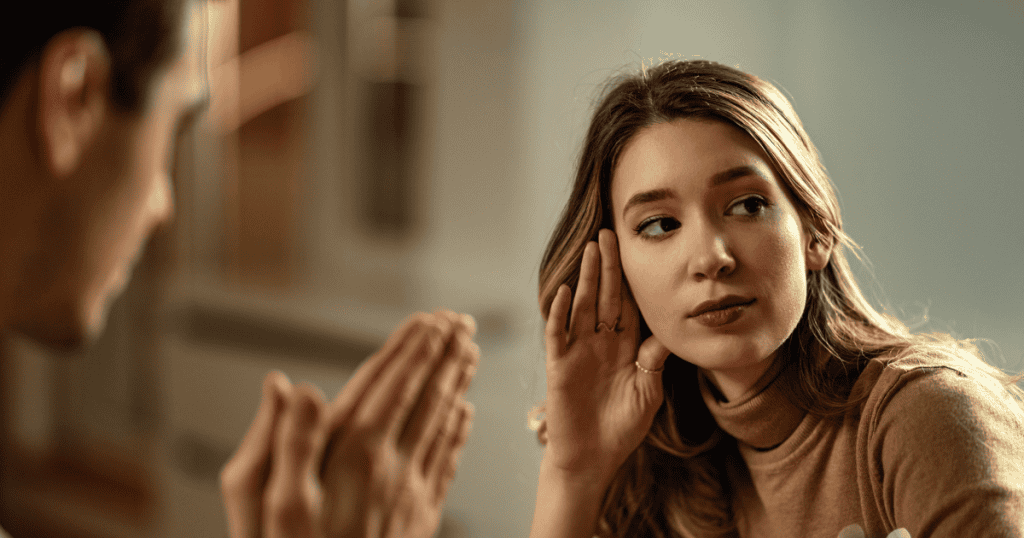 A young woman leans away with a cool, dismissive look while the man in front of her gestures urgently, almost begging. Her body language says it all — she’s no longer willing to carry the blame that doesn’t belong to her.