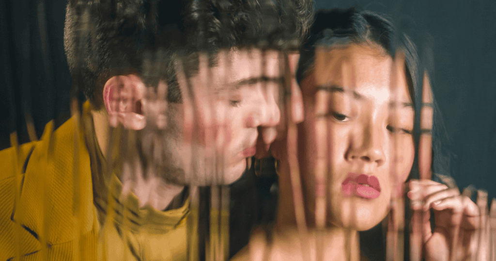 A man leans in closely toward a woman who looks away with detachment, representing the inner void narcissists can’t face.