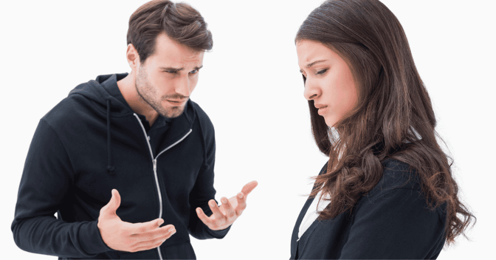 A frustrated man gestures wildly at a woman who looks away, displaying the volatile tension that erupts when a partner is no longer submissive enough to be controlled.