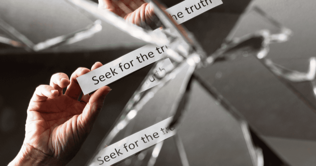 A hand reaches toward a shattered mirror where the words "Seek for the truth" are repeated on paper strips, highlighting the difficulty of finding clarity among broken pieces.