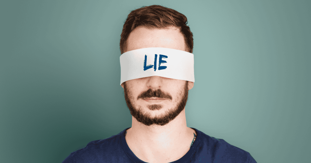 A bearded man stands with a white blindfold over his eyes featuring the word "LIE," illustrating a refusal to see or speak the actual facts.