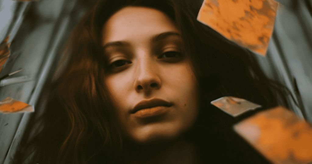 A woman gazes directly into the camera with a steady, unbothered expression, reflecting a shift in perspective that changes everything.