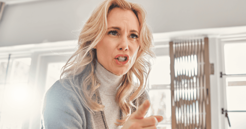 A woman points sharply with an accusatory expression, illustrating how a narcissist weaponizes someone else’s sensitivity to control, blame, and shift the narrative.