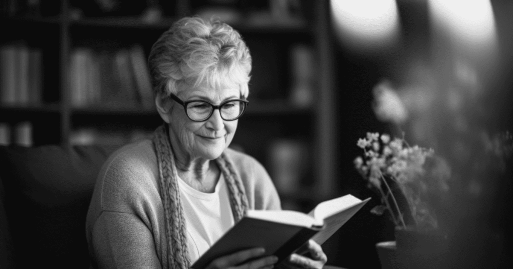 An older woman smiles thoughtfully while reading a book, quietly recognizing the sudden inconsistency between someone's projected persona and their actual actions.