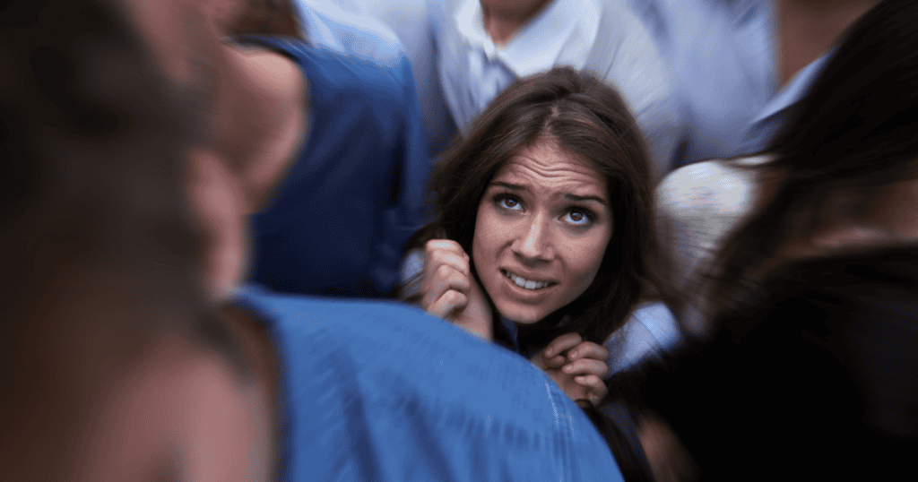 Woman overwhelmed in a crowd, illustrating echoism and emotional suppression struggles.