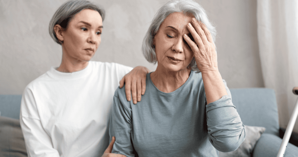 One woman comforts another who is holding her head in distress, illustrating the heavy emotional burden that truth-telling often carries.