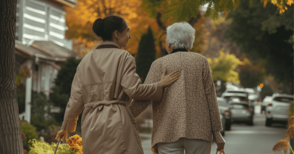 Two women walk down a sunlit street with one supporting the other, reflecting the protective instinct that often masks an underlying imbalance.