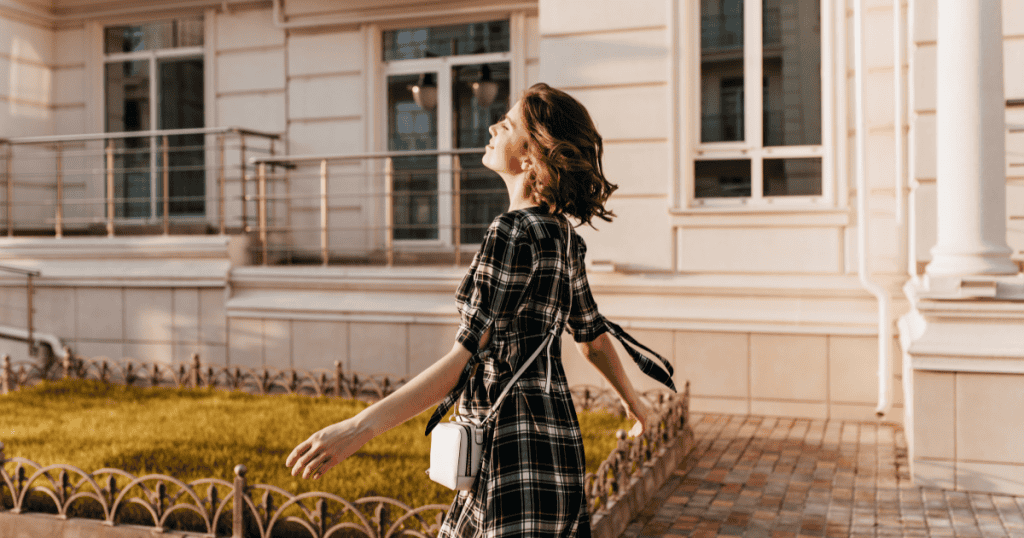 A woman walking freely in warm sunlight with arms open and face lifted, capturing the bittersweet freedom of realizing your narcissistic ex didn't just lose you — they lost the only place they ever felt emotionally safe.