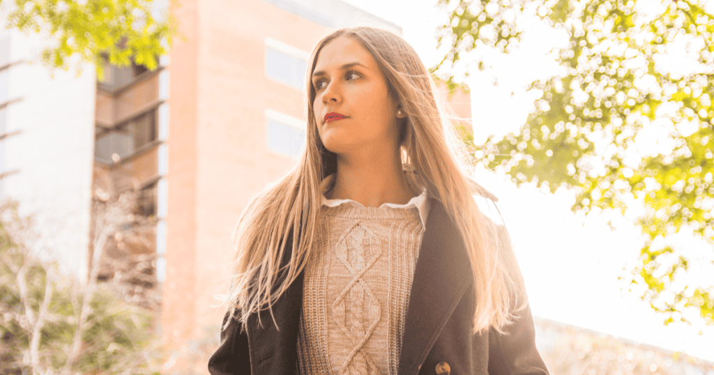 A woman gazing reflectively into the distance in golden light, embodying the empath who silently carries every wound, detail, and broken promise the narcissist will never acknowledge.